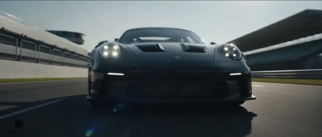 Black Porsche 911 GT3 RS on a race track, front view, AI video frame